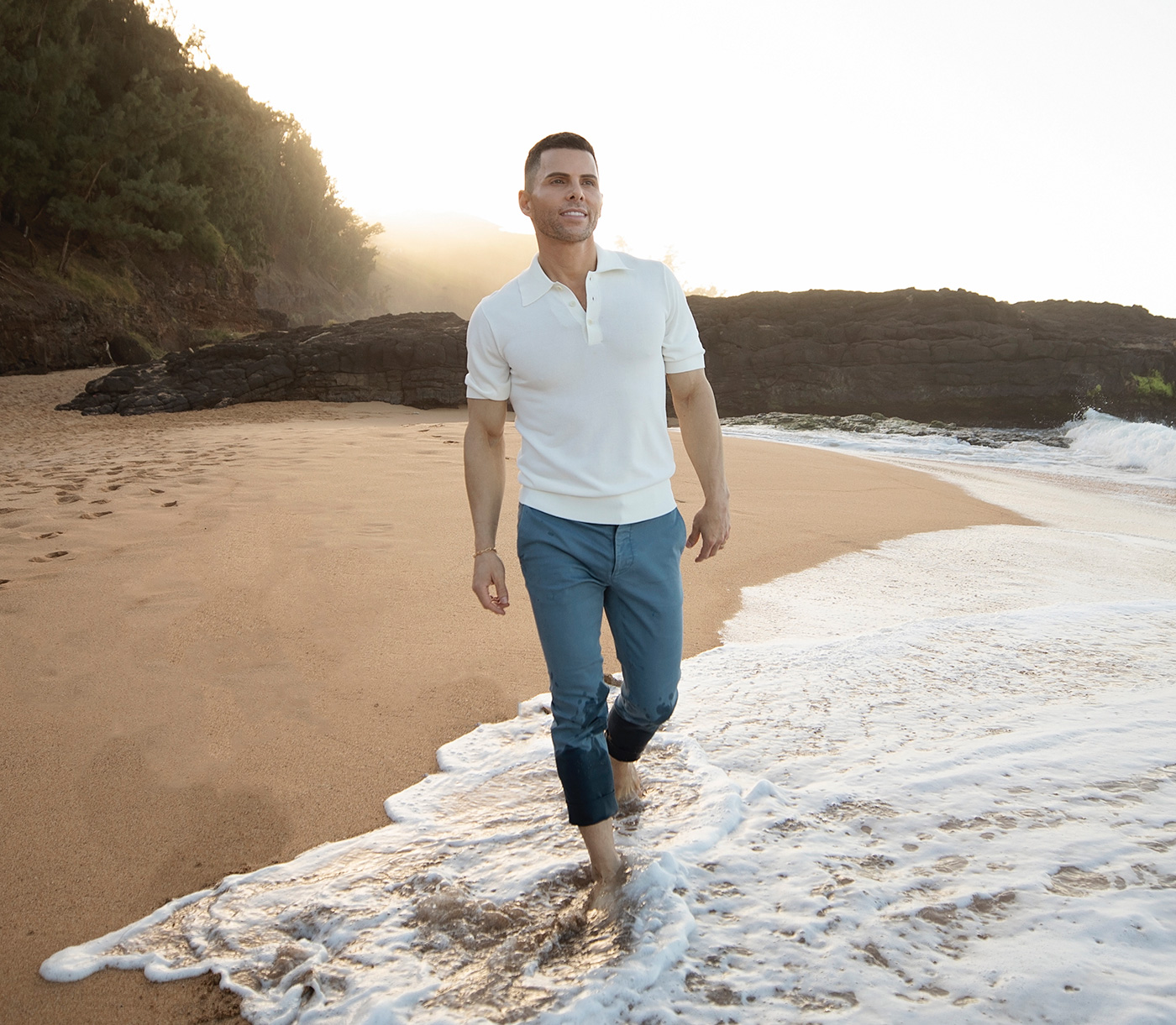 GT Dave walking barefoot along the water on a beach