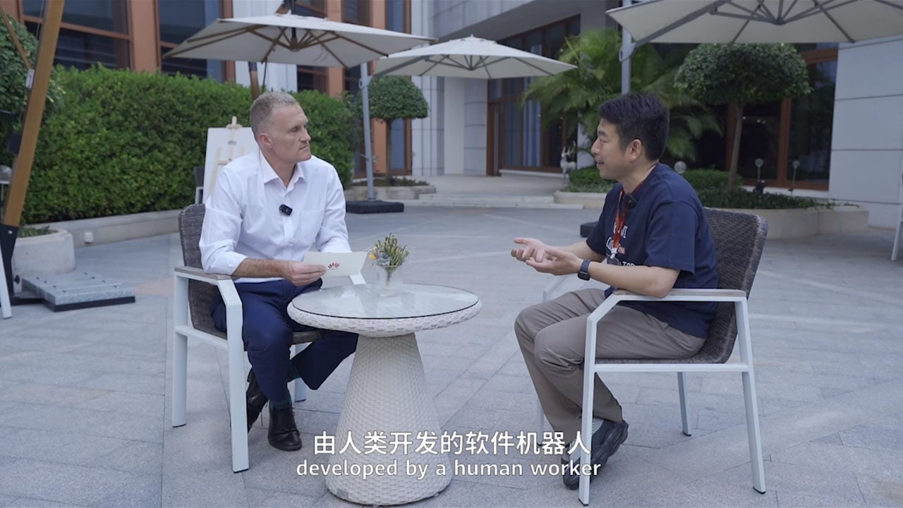 Guanchun Wang, right, speaking with Gavin Allen during an outdoor interview