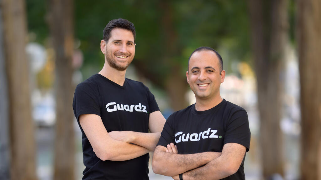 Guardz co-founders Dor Eisner and Alon Lavi wearing black Guardz shirts outdoors