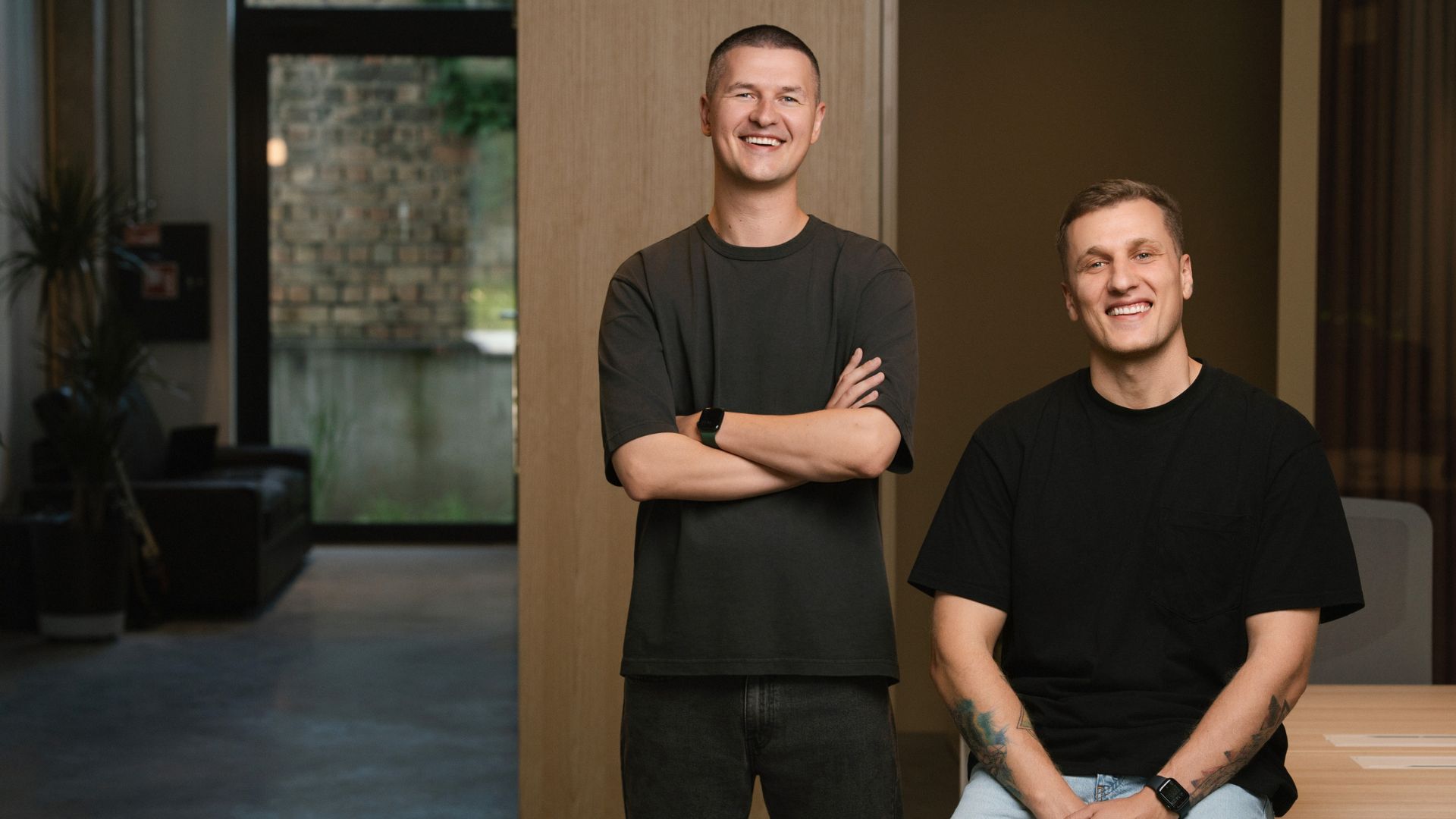 The two Guideless co-founders in black shirts in a modern office
