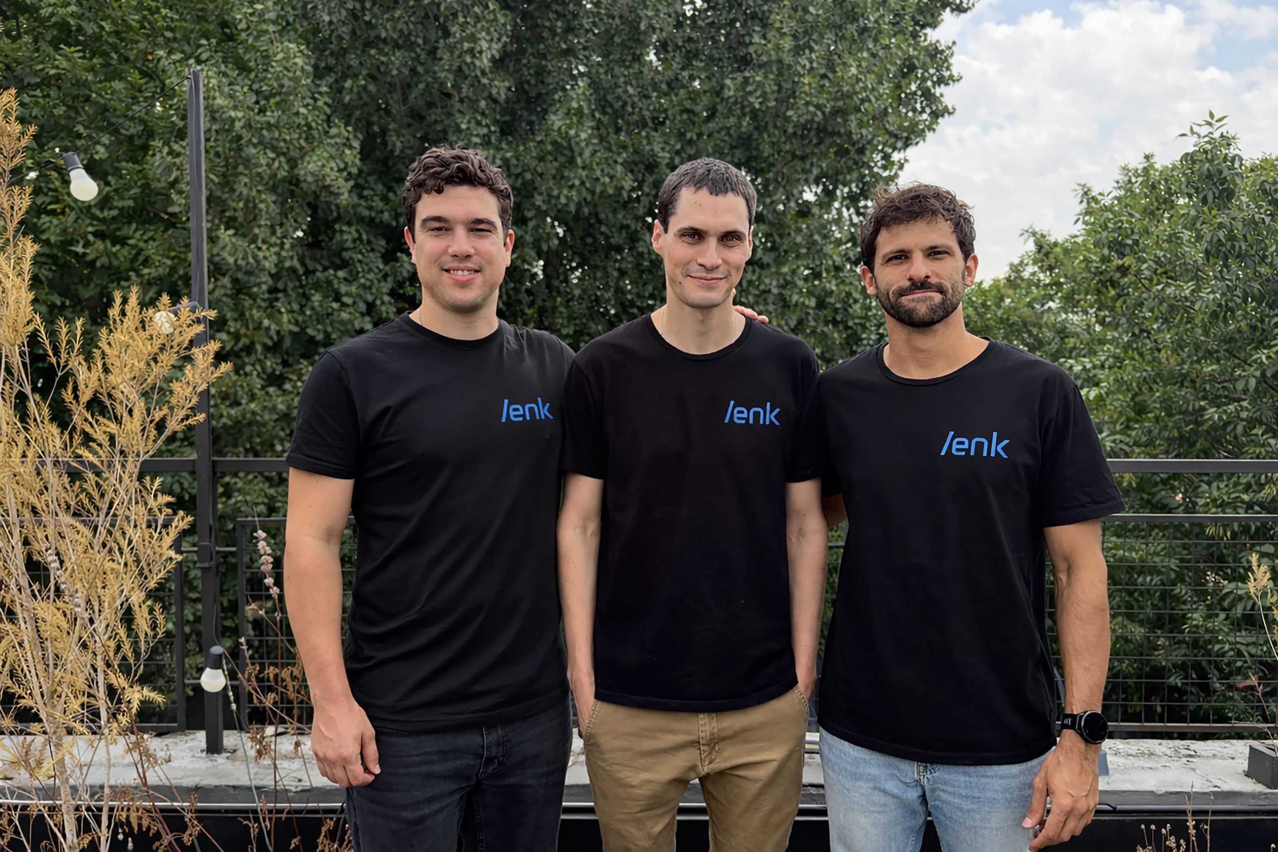 Lenk co-founders Nicolás Piqueras, Guido Galanter and Tomás Gropper standing outdoors in black Lenk shirts