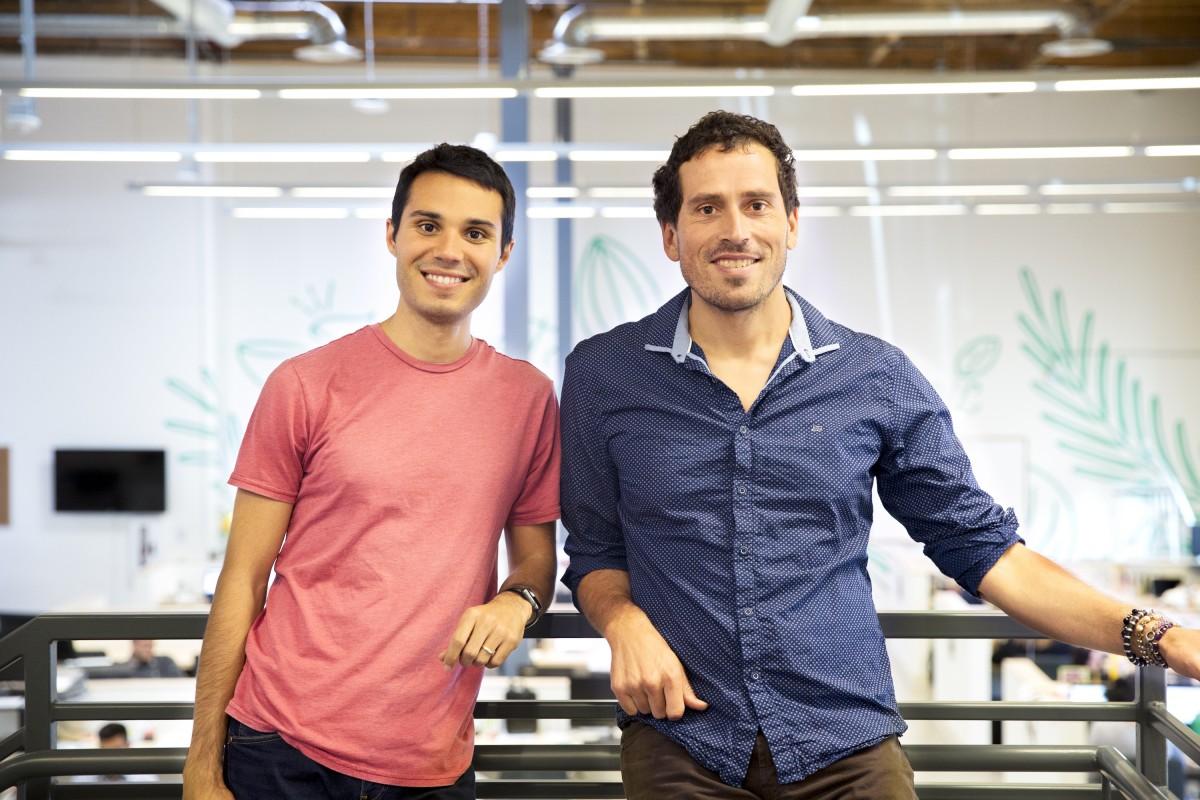 Nick Green, left, and Gunnar Lovelace, right, standing at a railing in the Thrive Market office