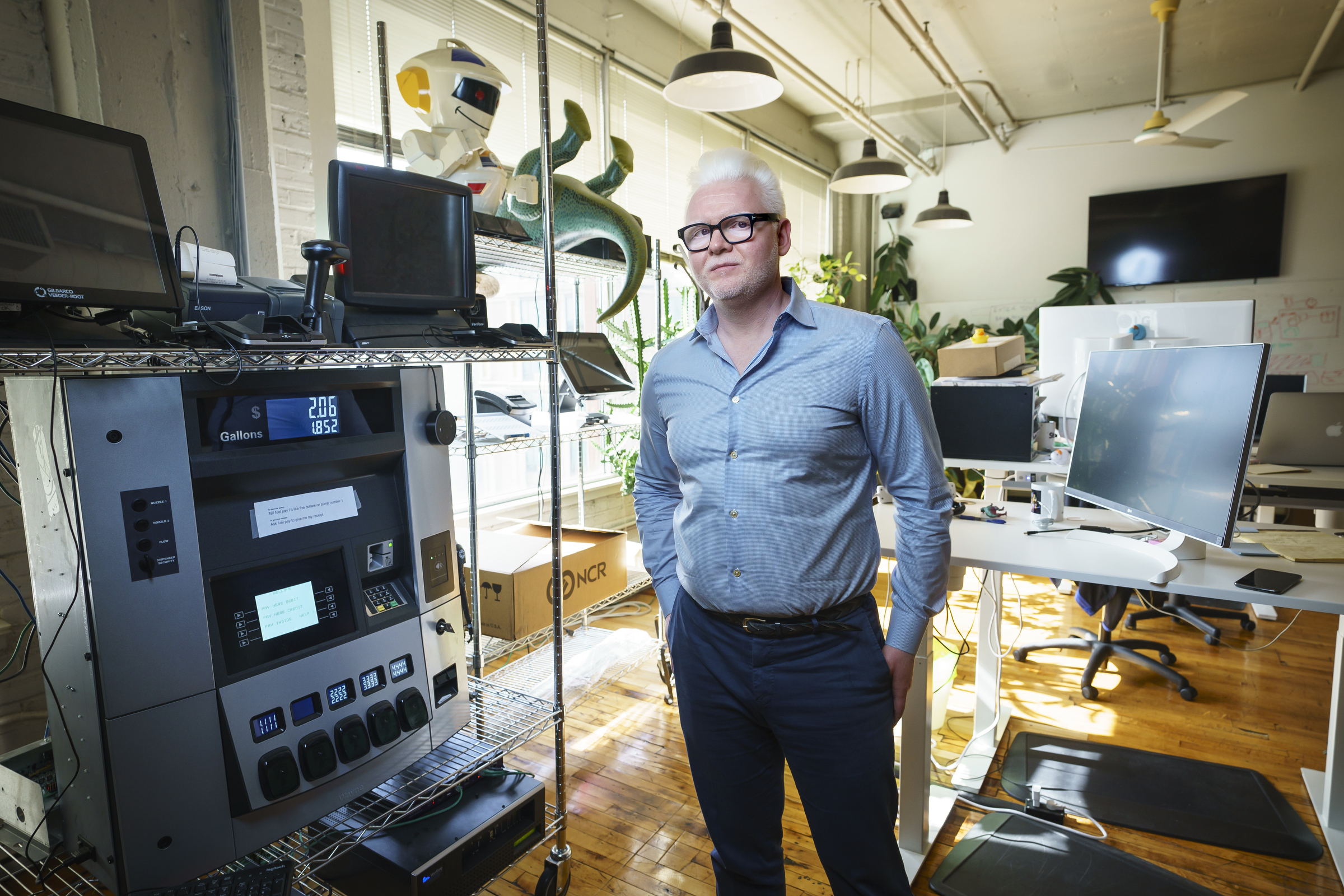 Gunter Pfau in Stuzo’s Philadelphia office beside a fuel dispenser and retail testing equipment