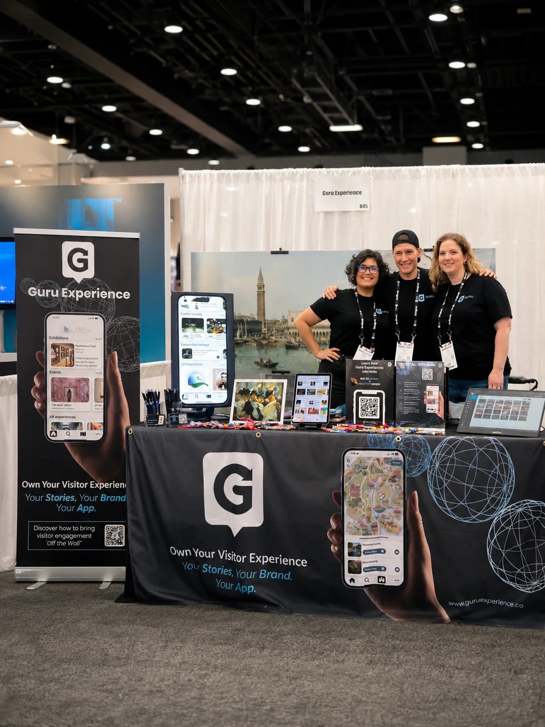 Dana Duran, Suzie Dergham and Kealy Gordon at a Guru exhibition booth