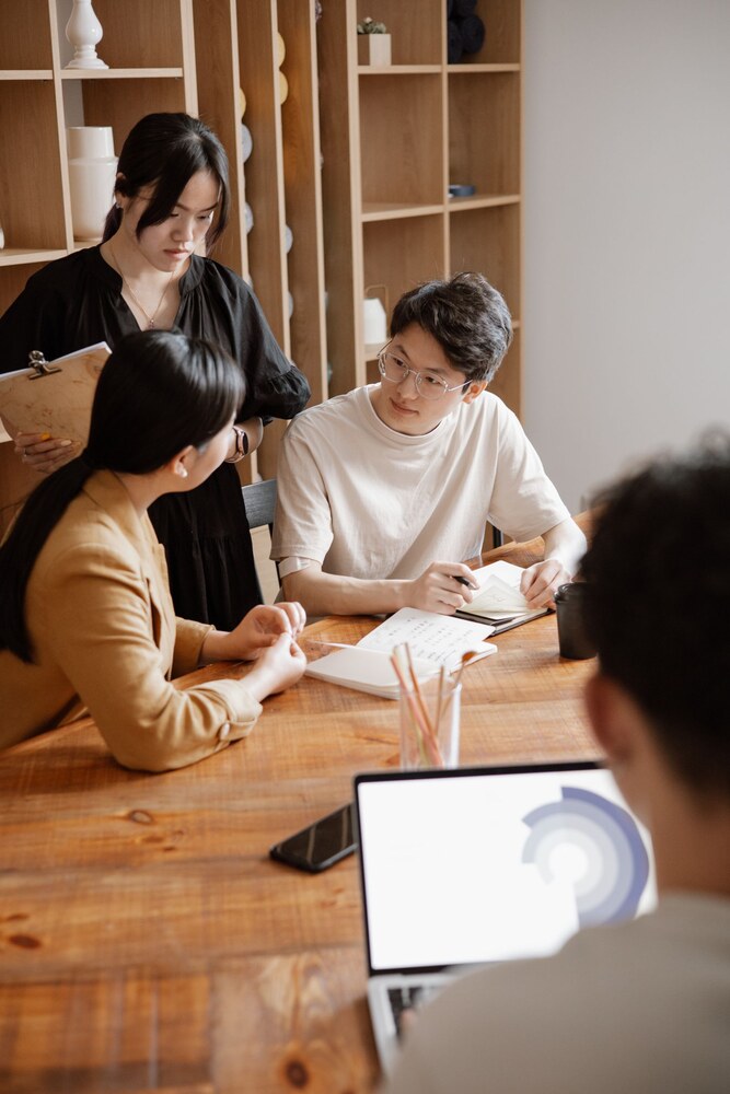 A small team reviewing work together around a table