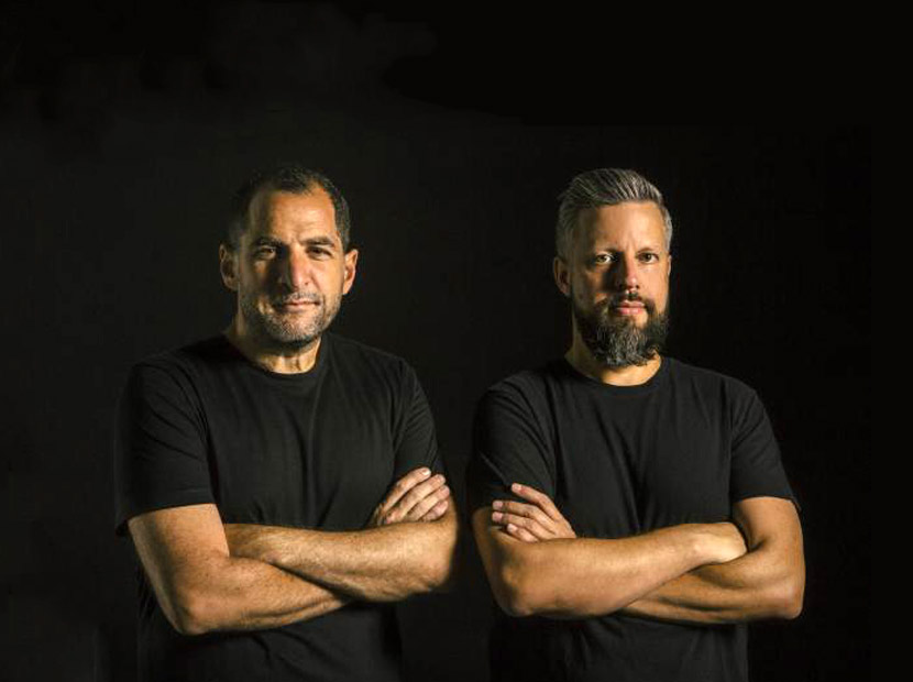GUT founders Gastón Bigio and Anselmo Ramos wearing black shirts against a dark background