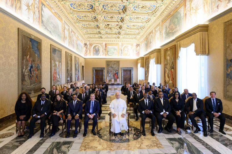 The Chicago delegation seated with Pope Leo XIV in a decorated Vatican room