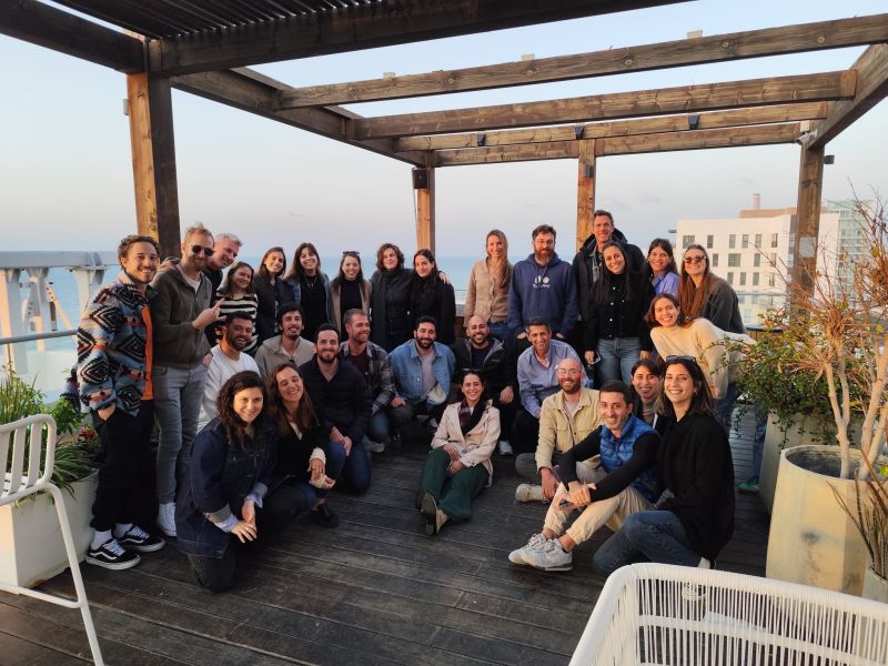 Guy Lalzary with the Connecteam marketing team at a rooftop offsite