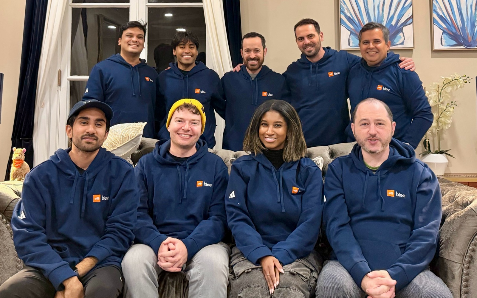 Guy Shahar with members of the Blee team in matching navy sweatshirts