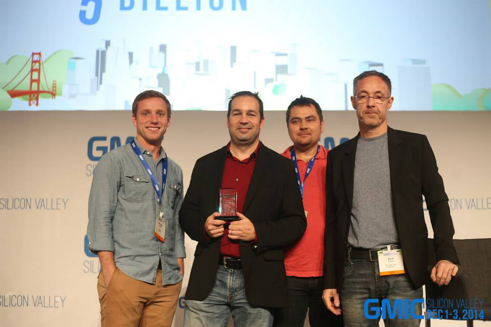 G-Startup winners gathered onstage with award placards in a GMIC archive photograph
