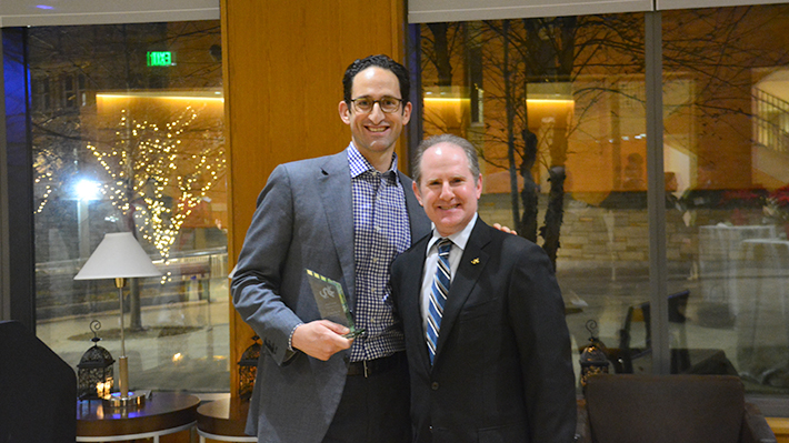 H. Adam Holt, left, holding his award at Drexel’s 2017 EMBA Alumni Awards