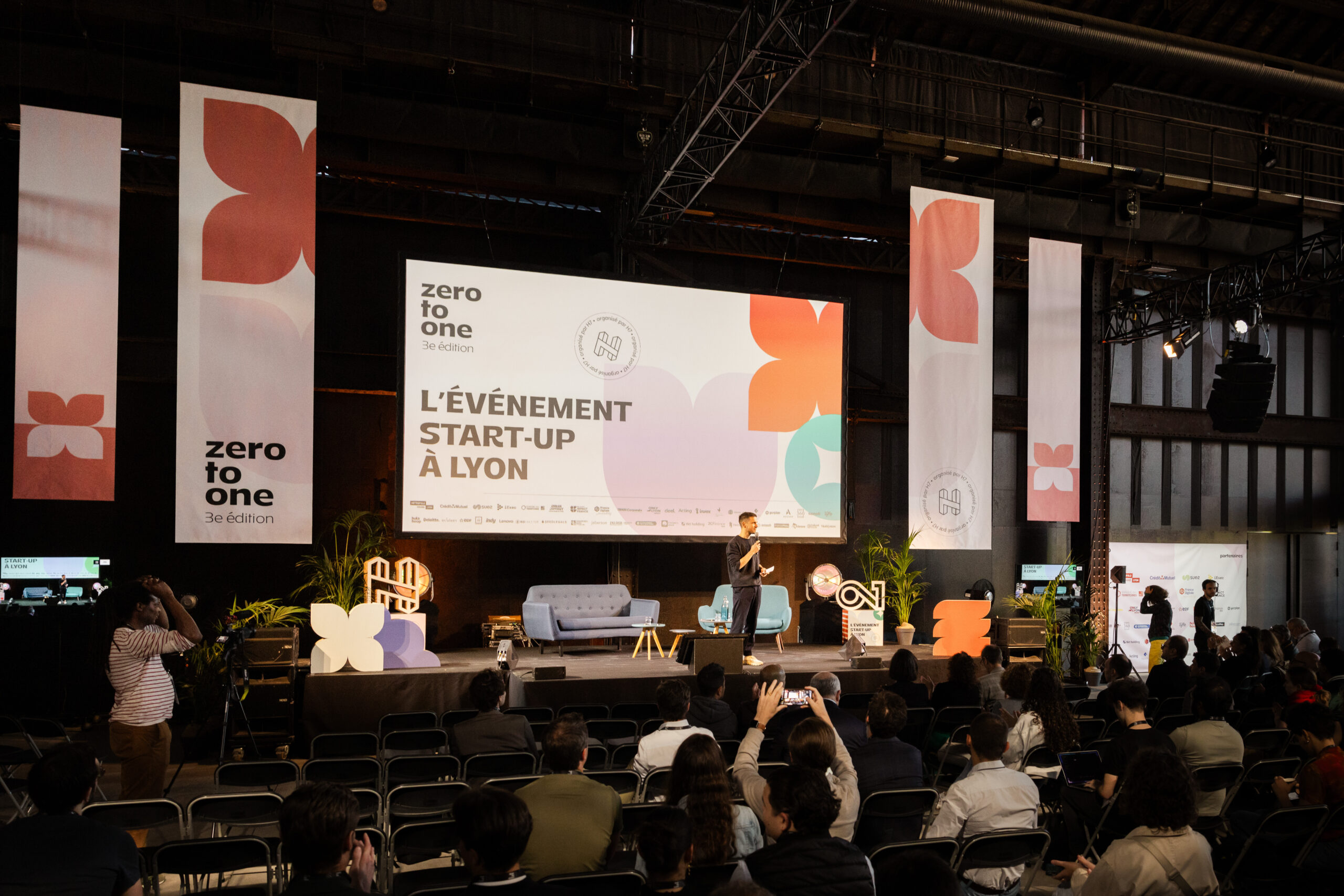 A speaker addresses an audience at the third edition of H7’s zero to one event