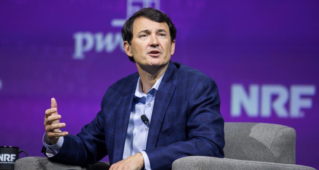 Hal Lawton seated onstage, speaking at NRF 2024