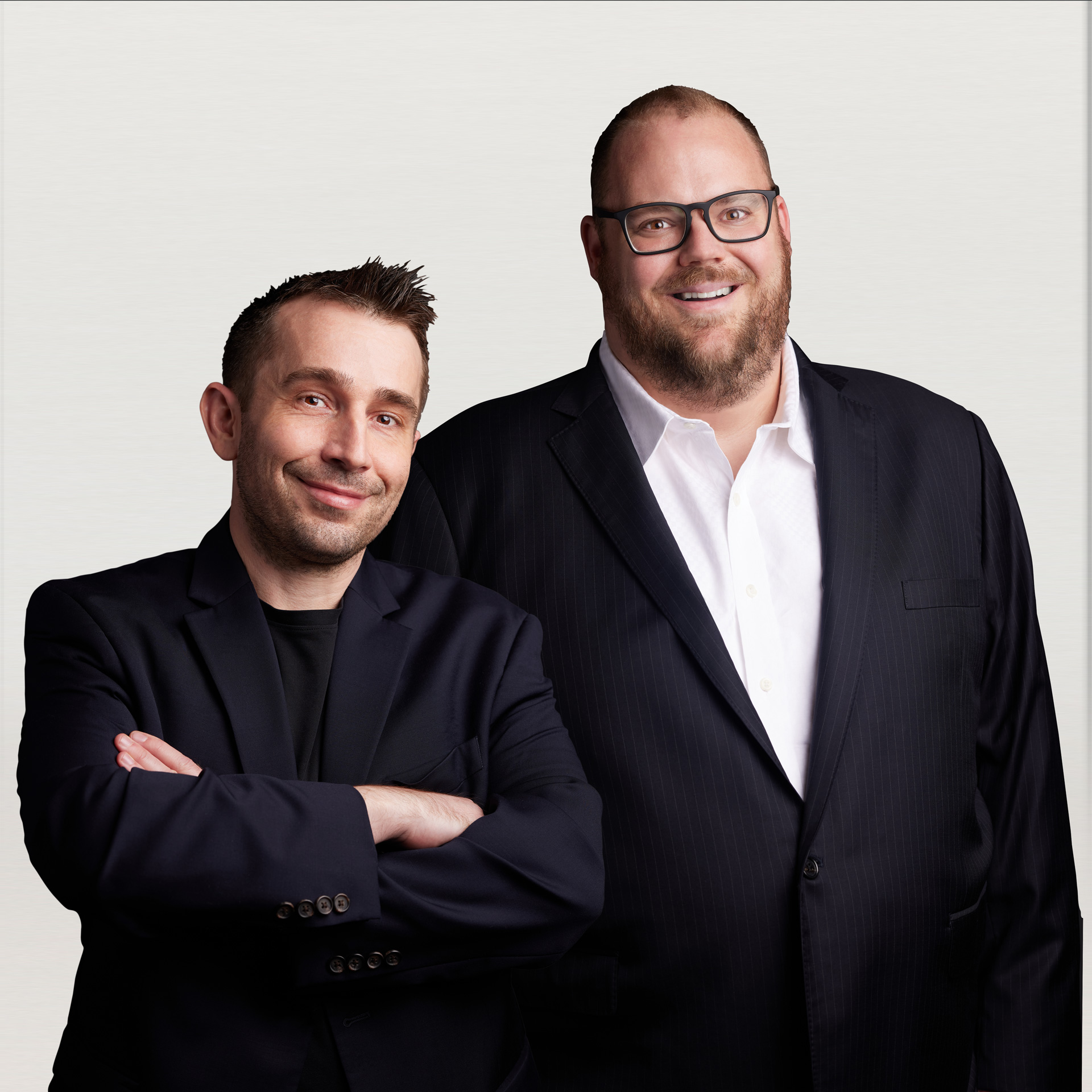 Halcyon co-founders Ryan Smith and Jon Miller standing together in dark jackets