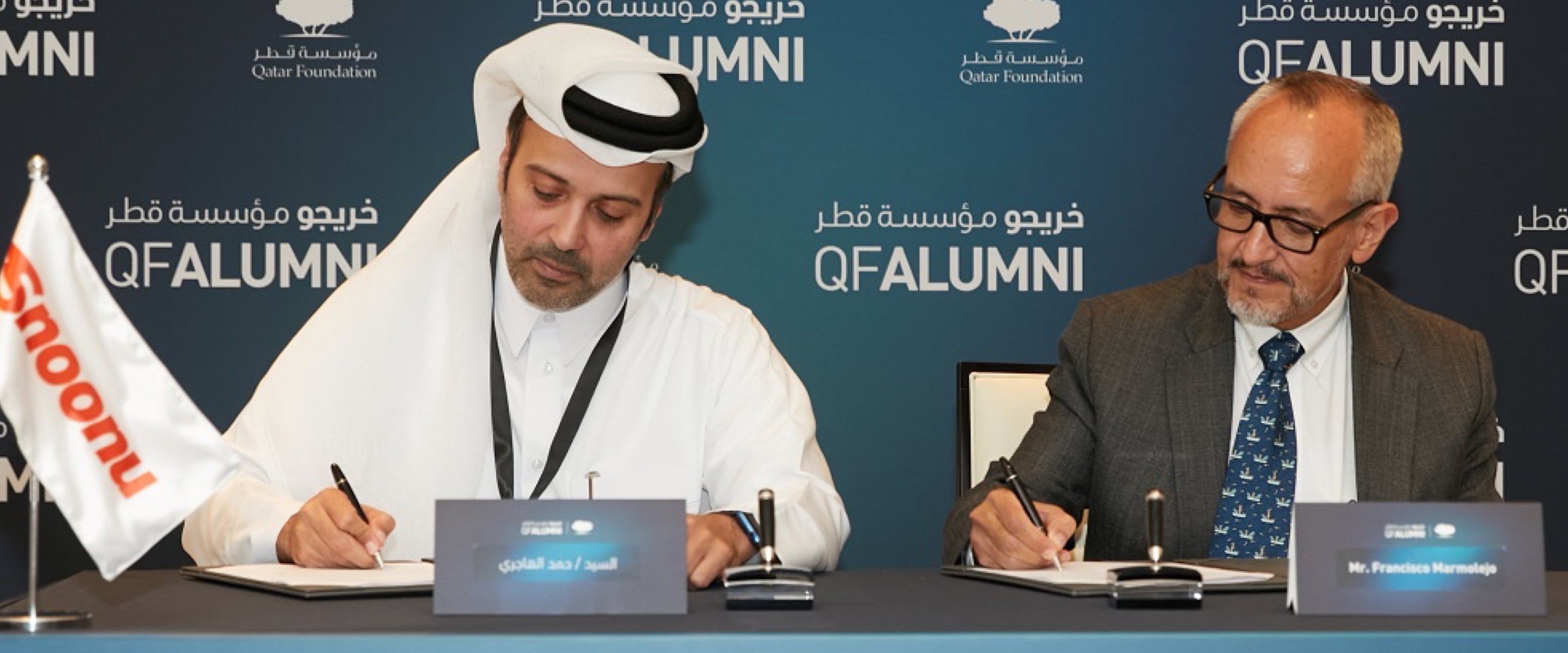Hamad Al-Hajri, left, signing the Qatar Foundation alumni partnership in 2022