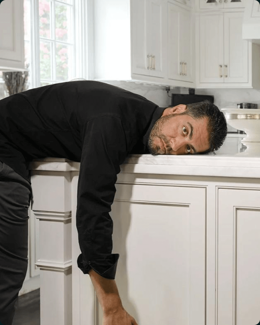 Hampton co-founder Joe Speiser resting his head on a kitchen counter