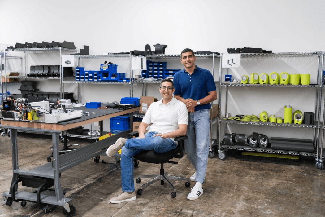 Maven co-founders Hamza and Khalid Derbas in a workshop surrounded by robot components