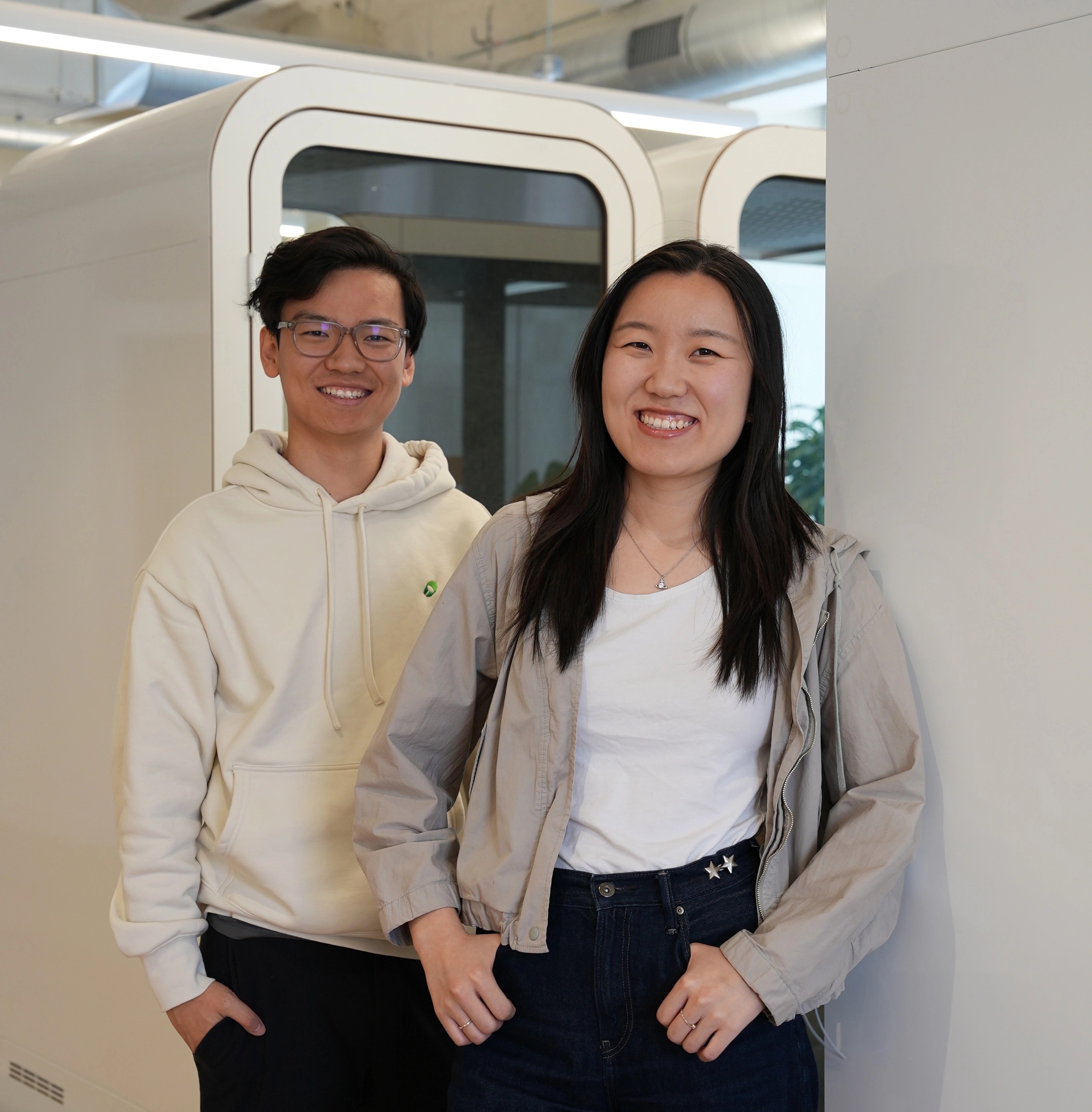 Han Wang, left, and Mintlify co-founder Hahnbee Lee standing together in an office