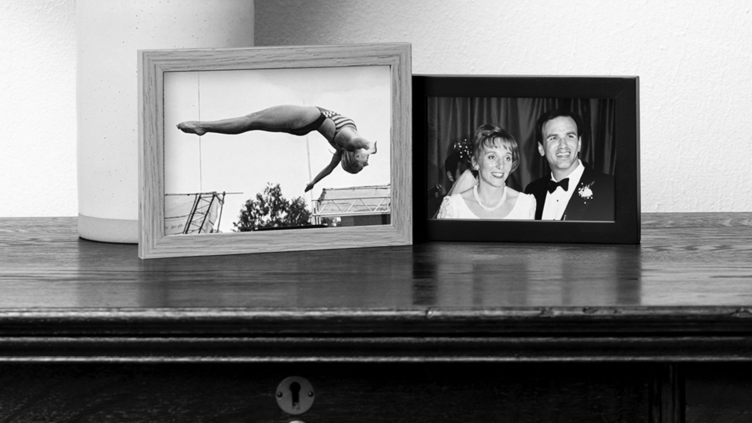 Framed archival photographs show Hanneke Faber diving and with Aristotle Economon at their wedding