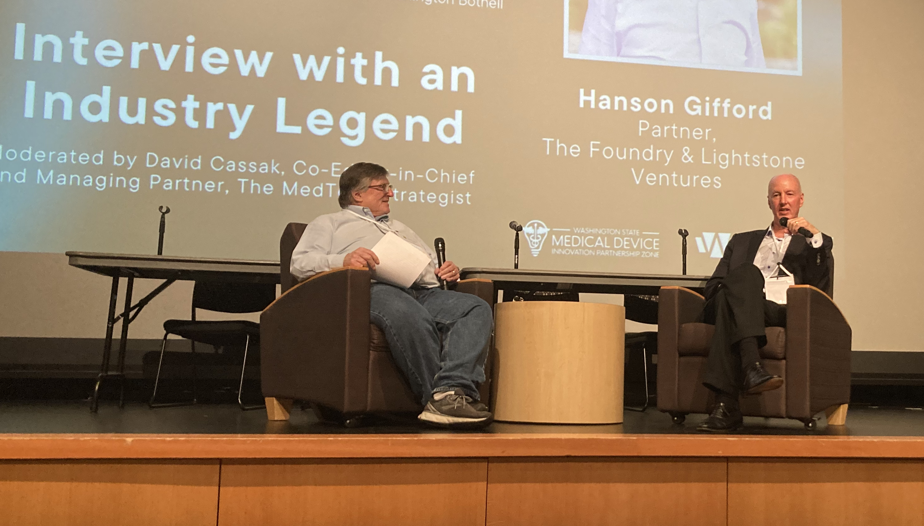 Hanson Gifford, seated at right, speaking with interviewer David Cassak onstage at the 2022 Washington State Medical Device Summit.
