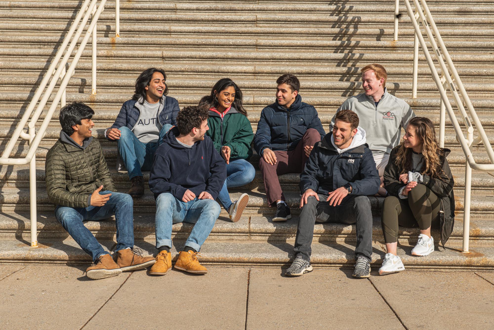 Eight people sitting together on outdoor steps in the group photograph published by Happy Valley VC