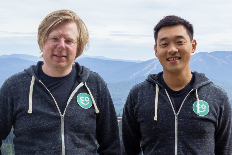 HappyCo co-founders Andrew Mackenzie-Ross, left, and Jindou Lee, right, wearing company hoodies outdoors