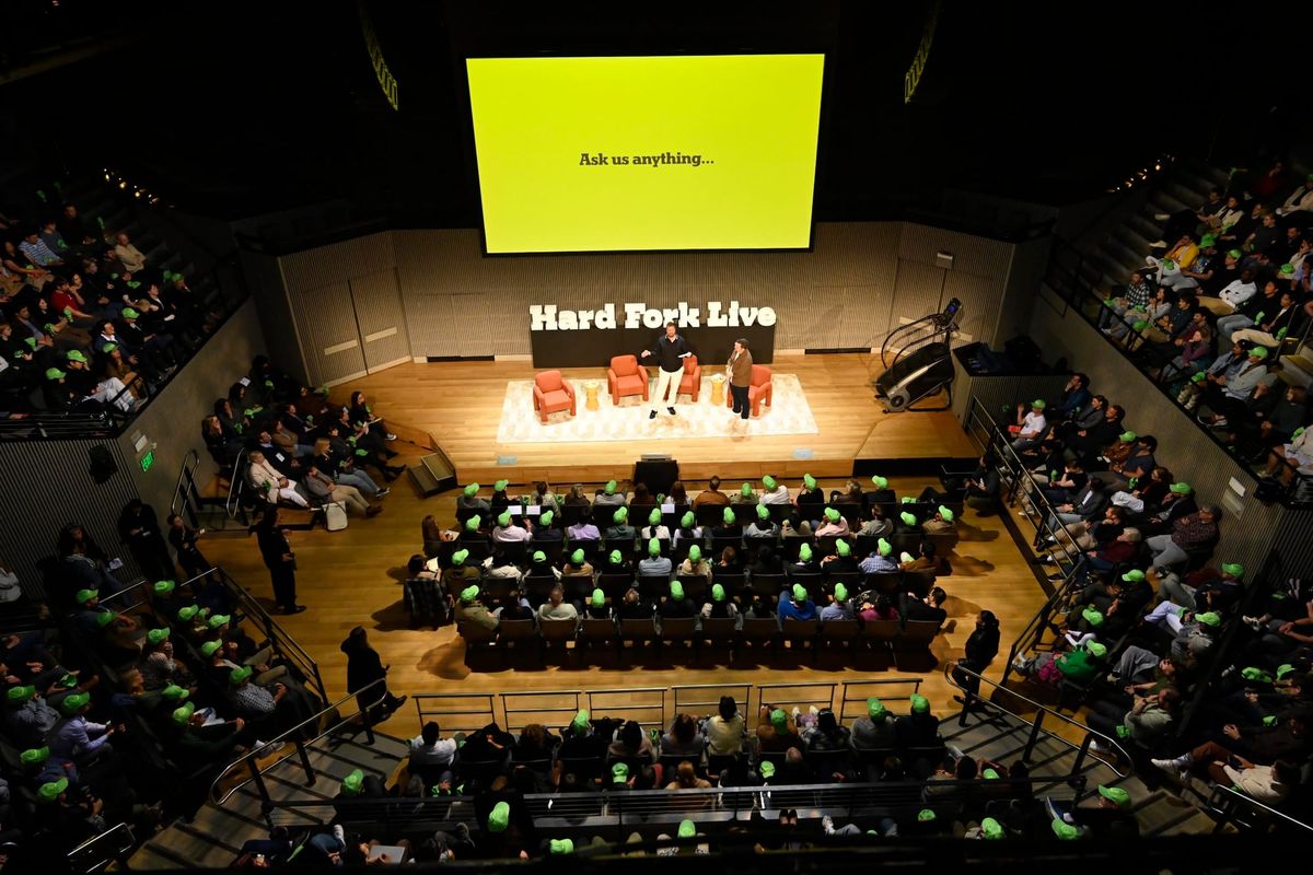 A packed auditorium watches the original Hard Fork hosts onstage in San Francisco