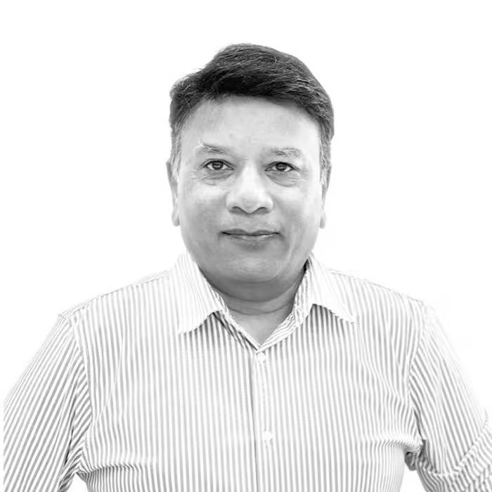 Haresh Kumbhani in a striped shirt, in a black-and-white photograph published by Zymr