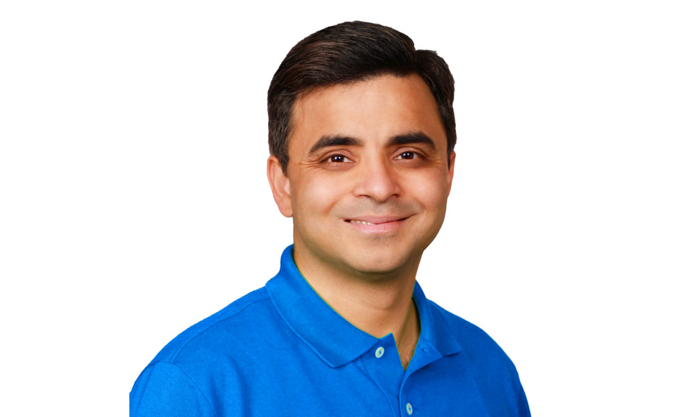 Harish Tejwani, wearing a blue polo, photographed for a 2025 interview