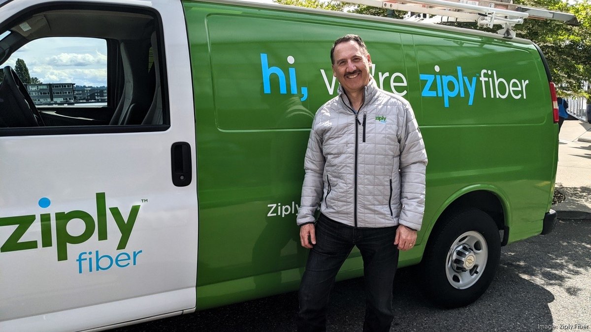 Harold Zeitz in a Ziply jacket beside a green and white Ziply Fiber service van