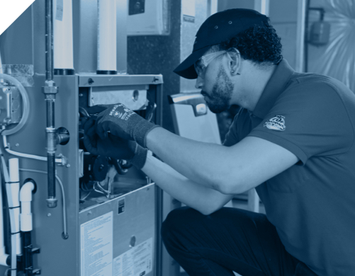 An Isaac technician working on heating and air conditioning equipment