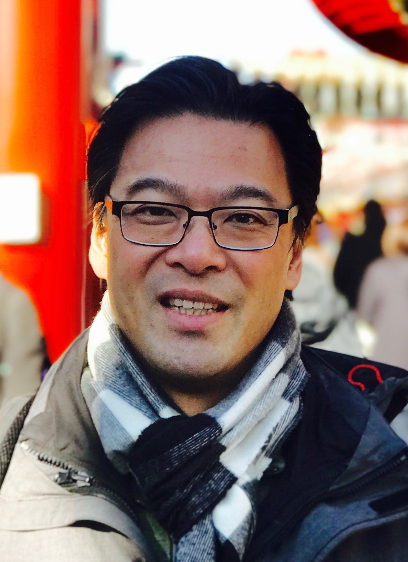 Harry Chan wearing glasses and a scarf