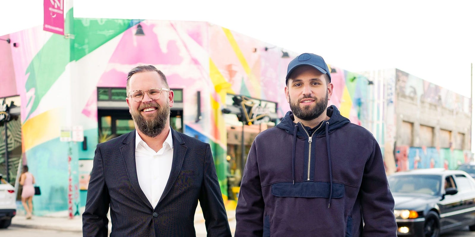 Michal Cieplinski, left, and Harry Hurst outside a colourful building in Miami