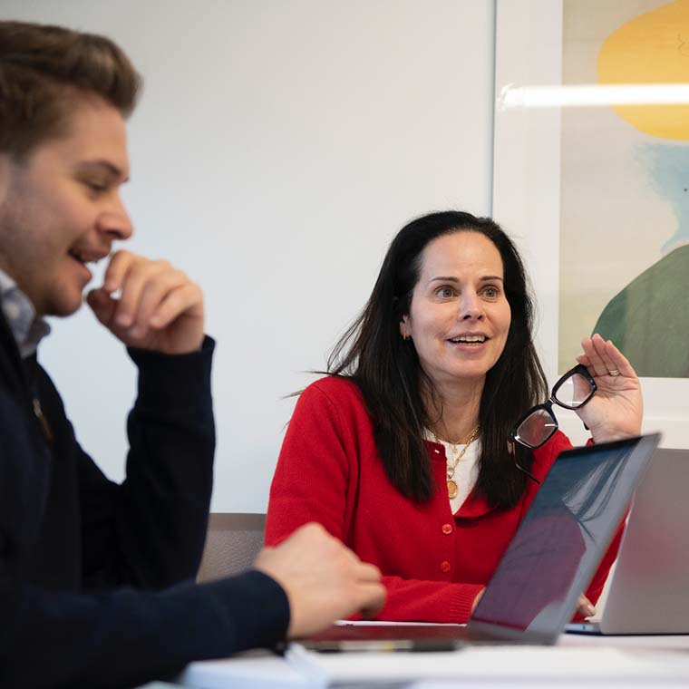 Harry Marketing colleagues in conversation around a conference table