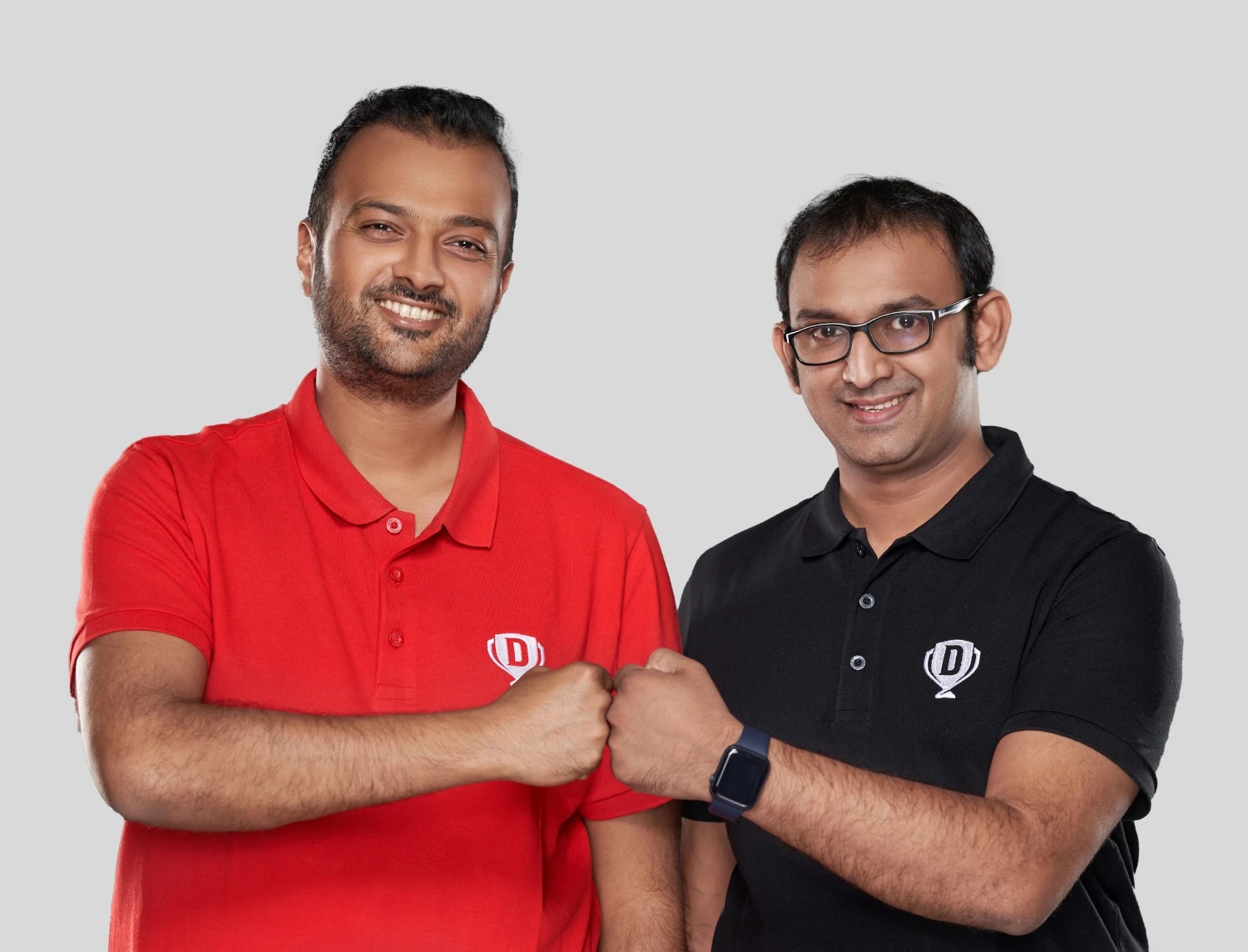 Harsh Jain, left, in a red Dream11 polo, alongside co-founder Bhavit Sheth in a black polo