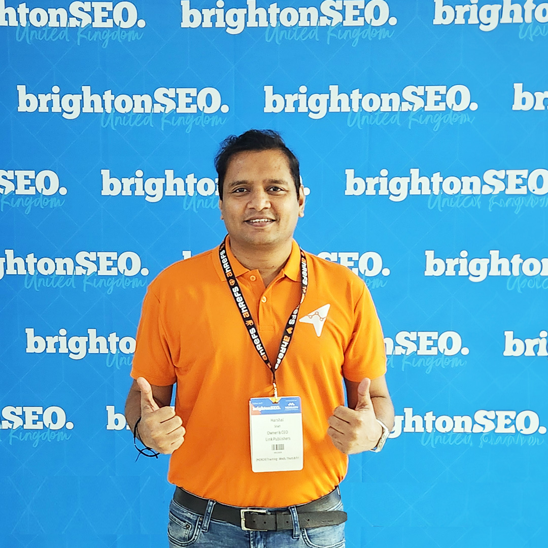 Harshal Shah wearing a Link Publishers shirt and conference badge at brightonSEO