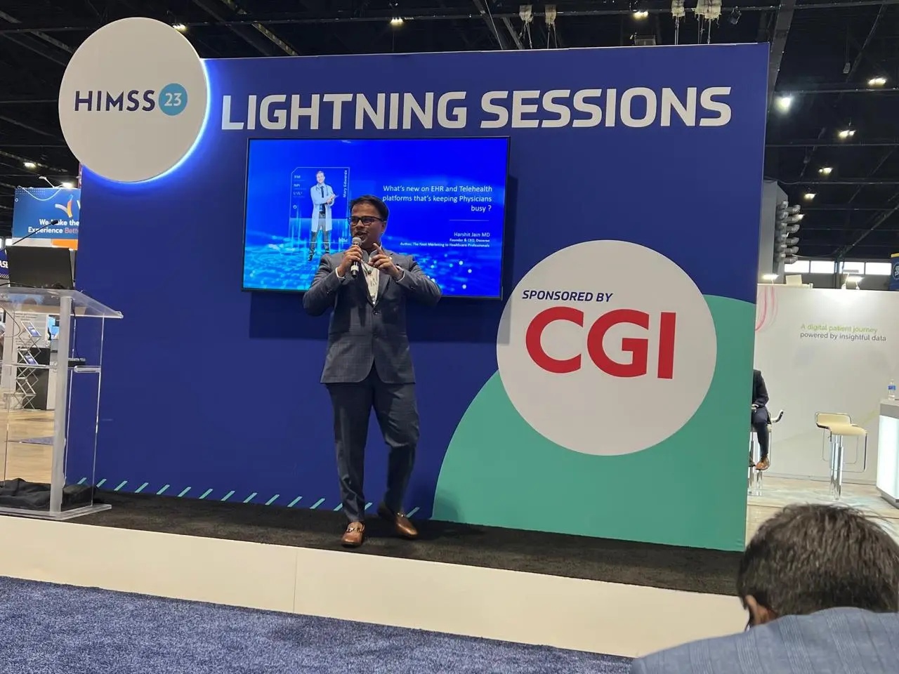 Harshit Jain speaking into a microphone at the HIMSS 23 Lightning Sessions stage