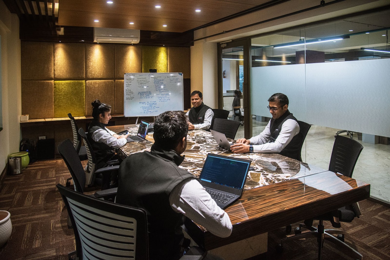 Harshvardhan Kariwala and the VComply team working around a conference table