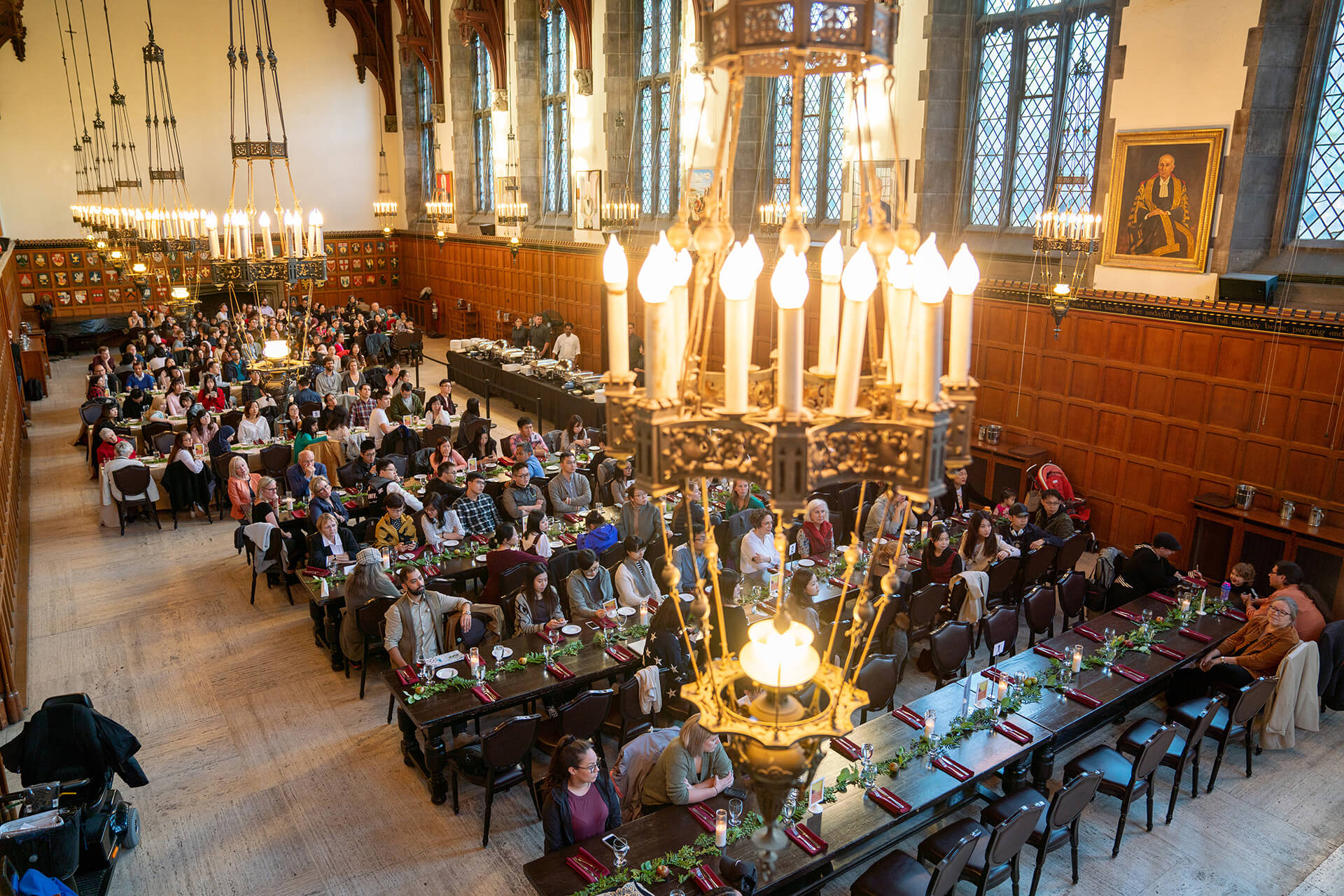 Guests seated at long tables in Hart House's wood-panelled Great Hall