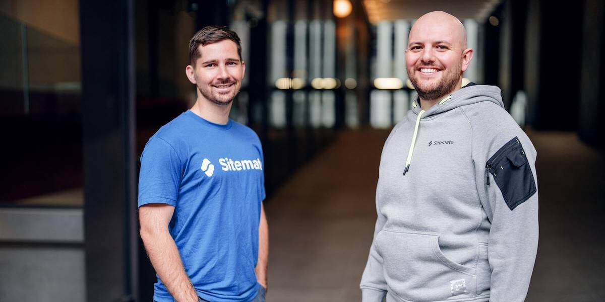 Sitemate co-founders Sam McDonnell on the left and Hartley Pike on the right standing in an office corridor