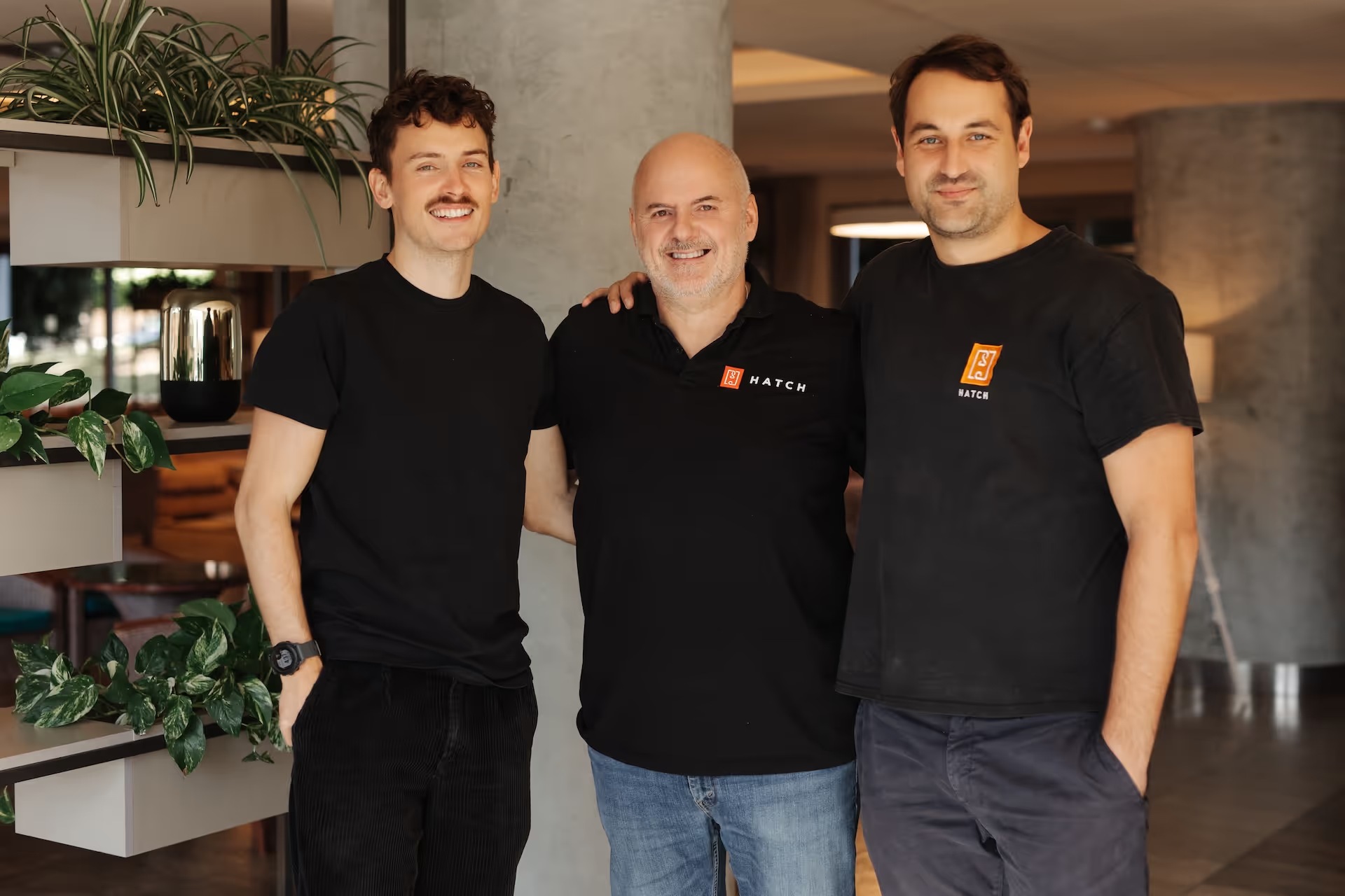 Hatch Blue’s three co-founders posing together indoors