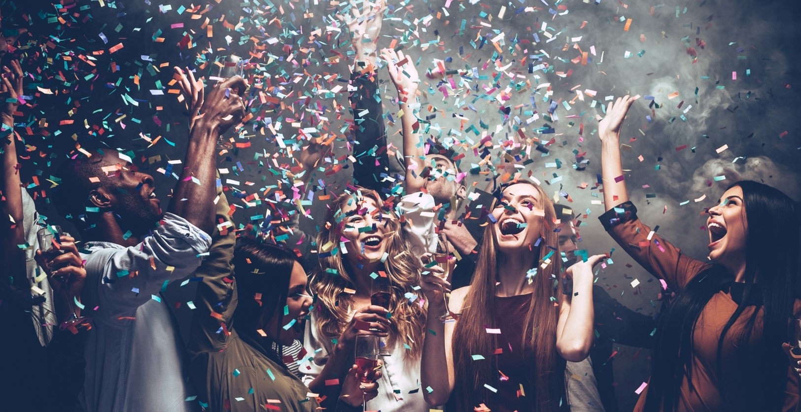 People celebrating beneath falling confetti in Lotto Social campaign imagery