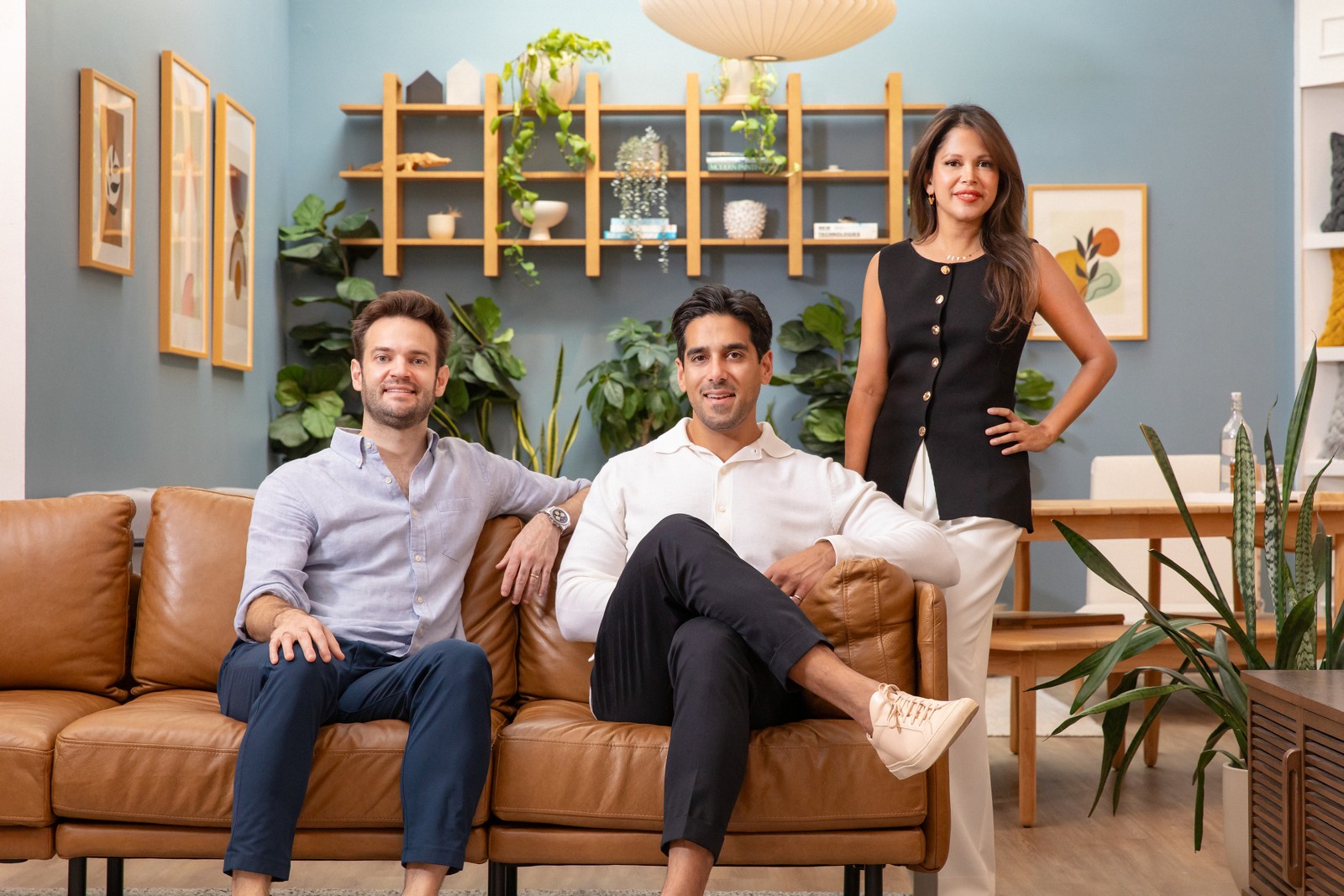 Burrow co-founders Stephen Kuhl and Kabeer Chopra with Havenly co-founder Lee Mayer in a furnished living room