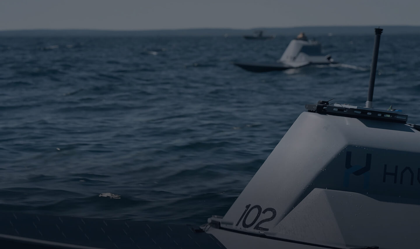 Several small HavocAI autonomous vessels operating at sea