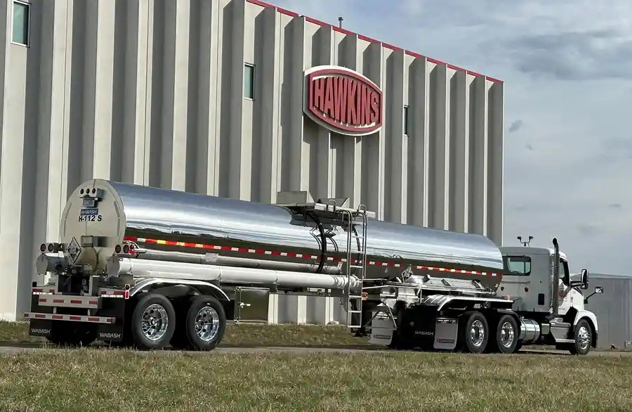 A Hawkins stainless-steel chemical tanker parked outside a company facility
