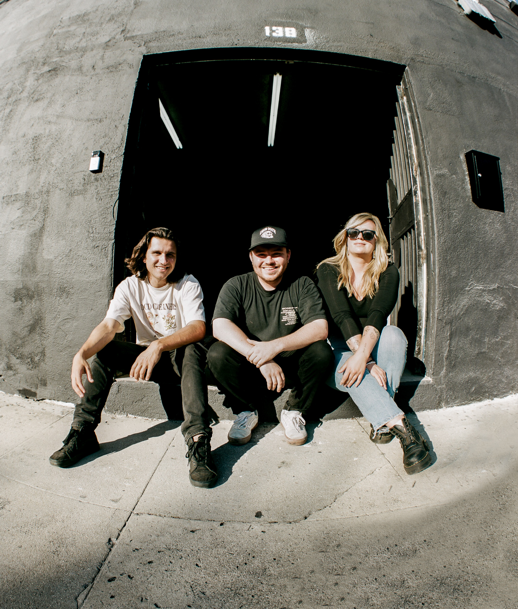 The three Hazy co-founders seated outside a building