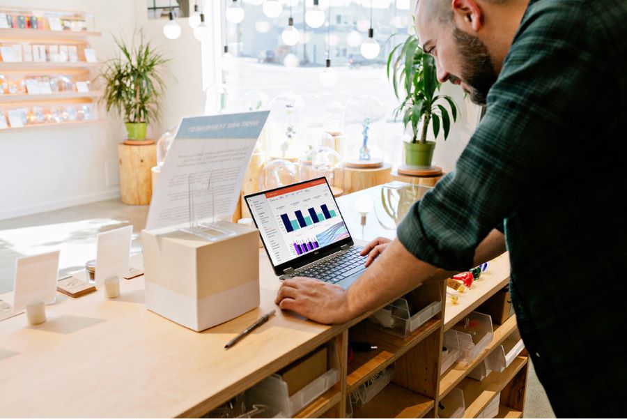 A cannabis retailer viewing Headset analytics on a laptop