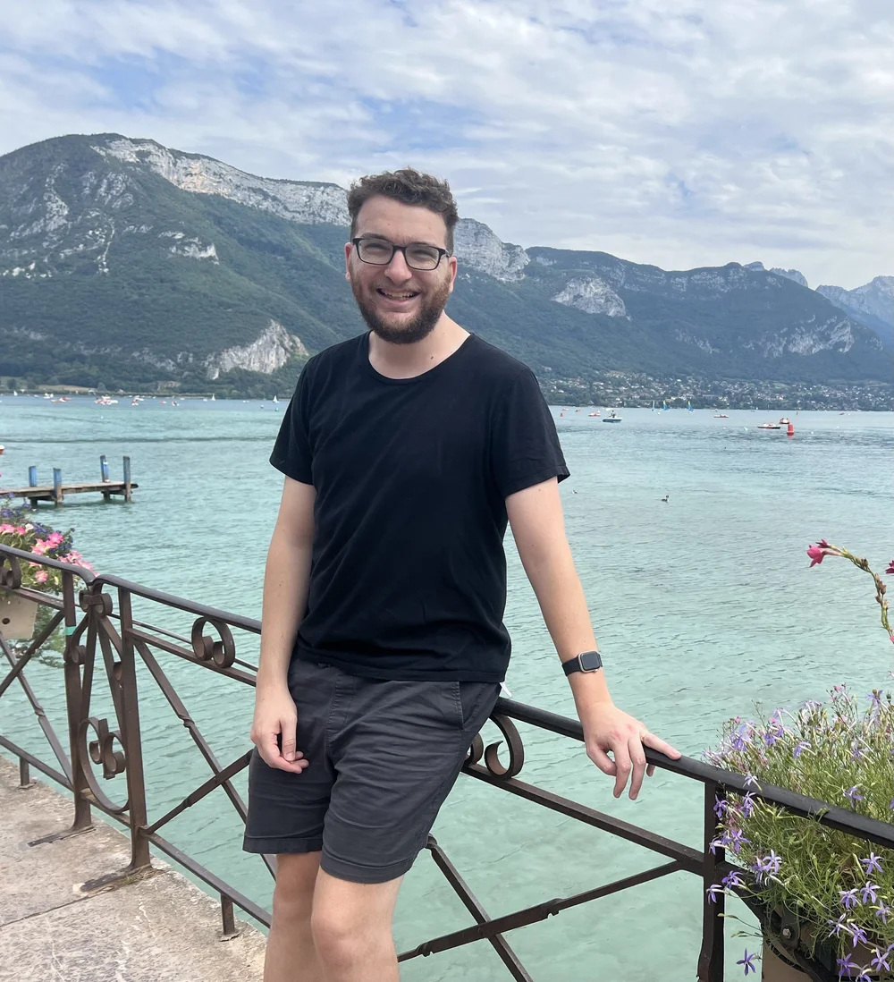 HeadStart founder Michael Stern standing beside a mountain lake