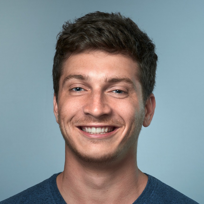 Studio portrait of Heal.me founder Max Coleman smiling