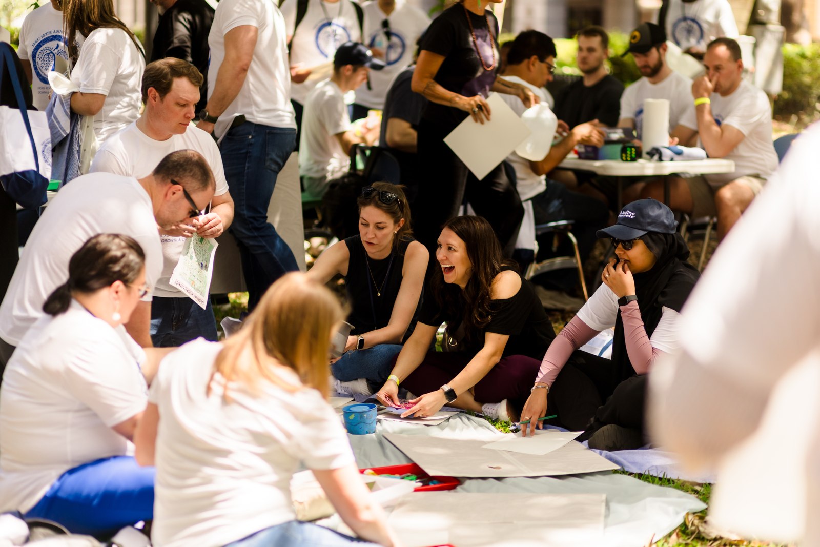 Participants gather around tables at a Health-E Commerce company event